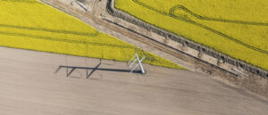 Aerial view of an electric power transmission line project under construction in an agricultural area.