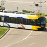 Light rail train at intersection.